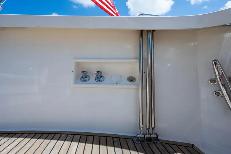 Slide: The Image of Close-up of the deck on a 2007 Grand Banks 43 Eastbay SX, featuring teak wood and stainless steel fittings. - 21