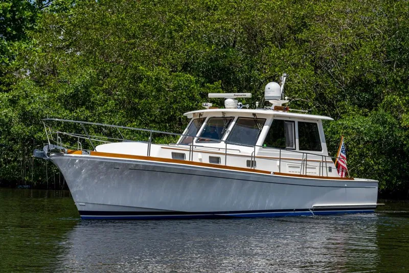 Slide: The Image of 2007 Grand Banks 43 Eastbay SX in a lush green setting. - 8