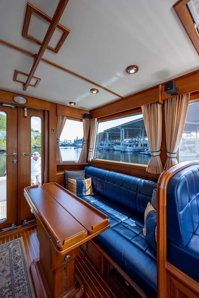 Slide: The Image of Interior of the 2007 Grand Banks 43 Eastbay SX with wooden table and blue leather seating. - 30