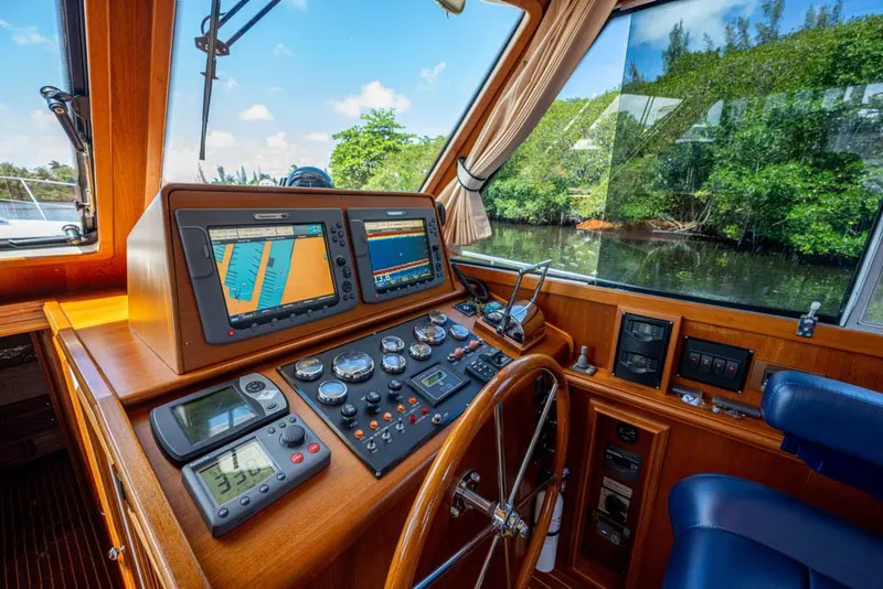 Slide: The Image of Helm of the 2007 Grand Banks 43 Eastbay SX with wood finish and modern navigation equipment. - 34