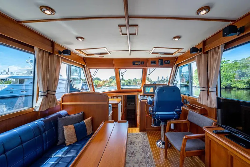 Slide: The Image of Interior of a 2007 Grand Banks 43 Eastbay SX with wood finish and blue upholstery. - 27