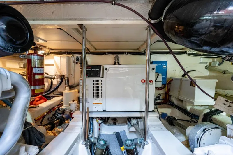 Slide: The Image of The engine room of a 2007 Grand Banks 43 Eastbay SX, featuring engines and technical equipment. - 49