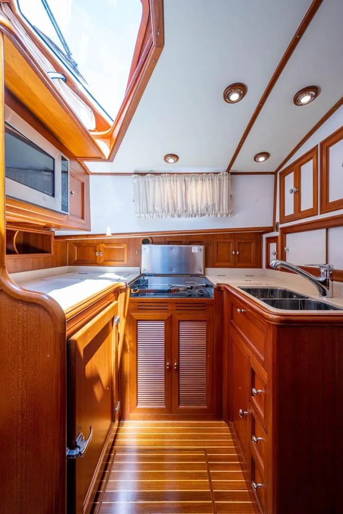 Slide: The Image of Interior of the 2007 Grand Banks 43 Eastbay SX with elegant wood finish and modern kitchen. - 39