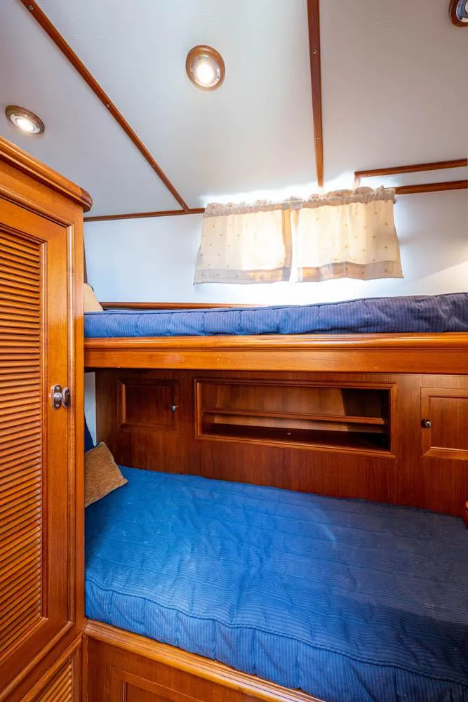 Slide: The Image of Interior of the 2007 Grand Banks 43 Eastbay SX with bunk beds and wooden furnishings. - 43