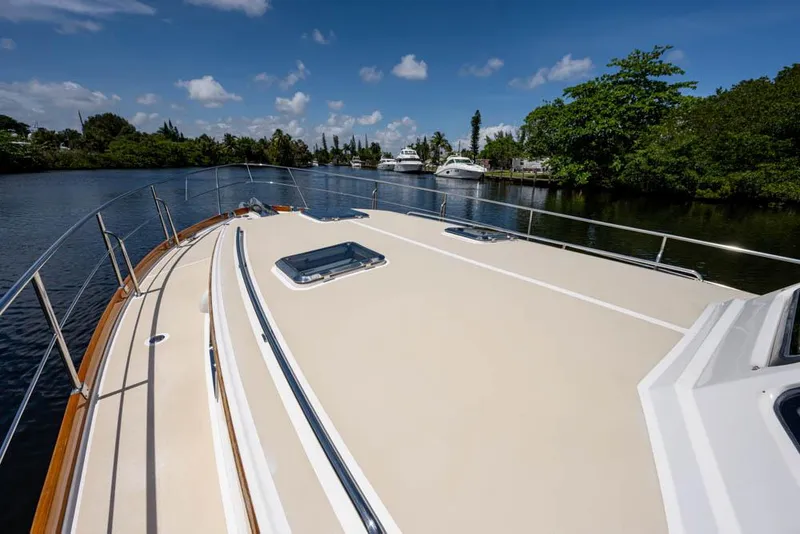 Slide: The Image of 2007 Grand Banks 43 Eastbay SX on a calm river with clear skies. - 17