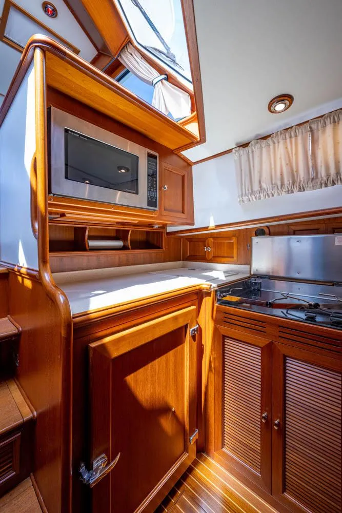 Slide: The Image of Interior of the 2007 Grand Banks 43 Eastbay SX with wooden cabinetry and modern kitchen. - 40