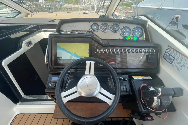 Slide: The Image of Cockpit of 2018 Sea Ray Sundancer 350 Coupe with navigation display and control panel. - 9