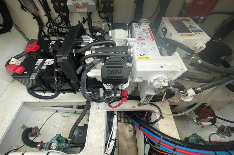 Slide: The Image of Engine compartment of a 2018 Sea Ray Sundancer 350 Coupe with visible batteries and wiring. - 28
