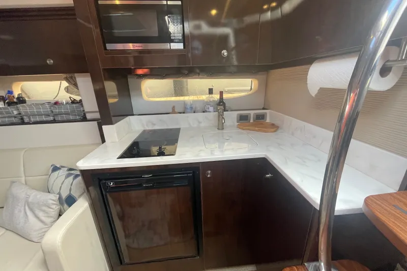 Slide: The Image of Luxurious 2018 Sea Ray Sundancer 350 Coupe kitchen with modern appliances and sleek design. - 21
