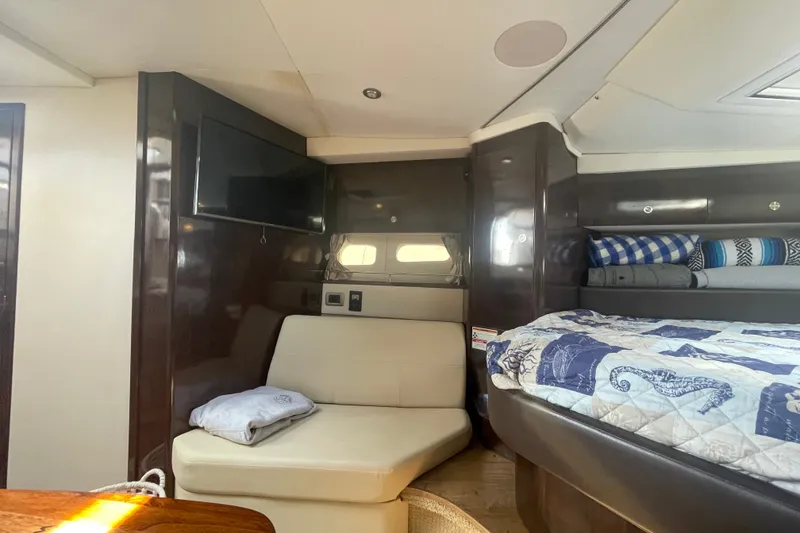 Slide: The Image of Interior of 2018 Sea Ray Sundancer 350 Coupe with cozy seating and stylish bedding. - 14