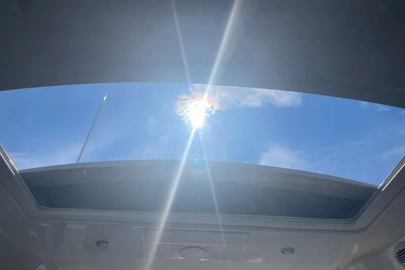 Slide: The Image of Sunlight streaming through the sunroof of a 2018 Sea Ray Sundancer 350 Coupe. - 34