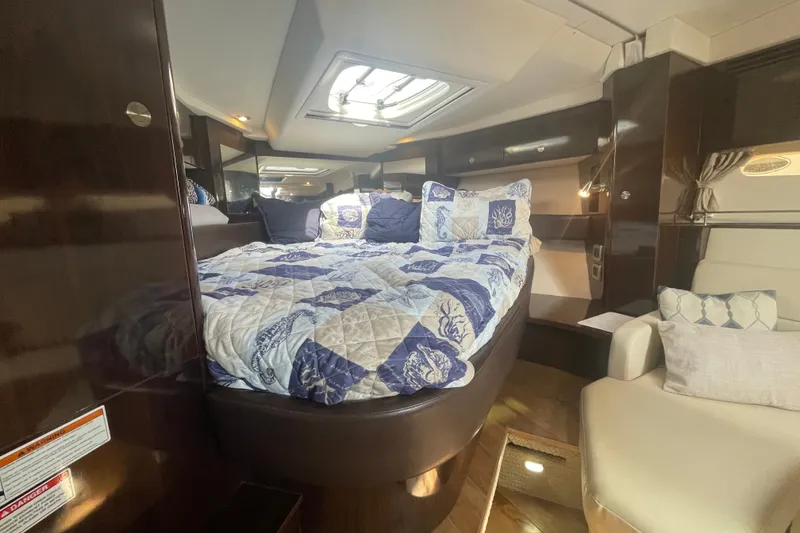 Slide: The Image of Luxurious interior cabin of 2018 Sea Ray Sundancer 350 Coupe with cozy bedding. - 24