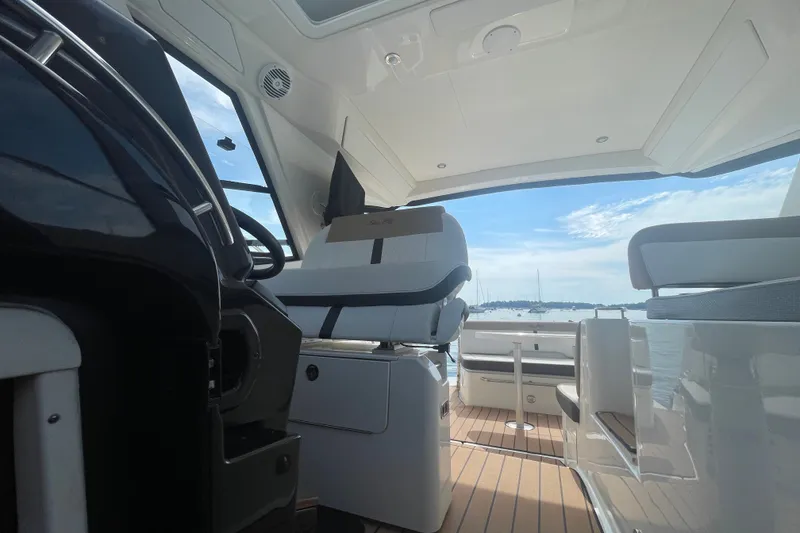 Slide: The Image of Interior view of 2018 Sea Ray Sundancer 350 Coupe with scenic ocean backdrop. - 25