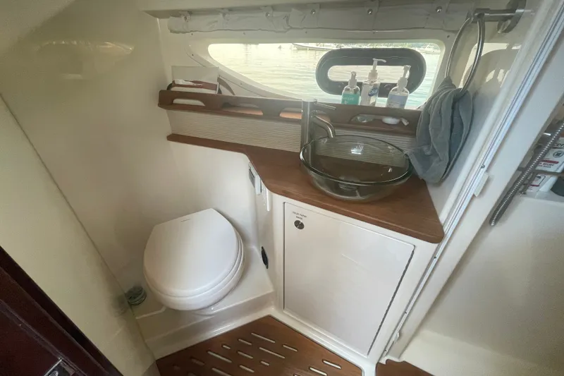 Slide: The Image of 2018 Sea Ray Sundancer 350 Coupe bathroom with modern sink and toilet. - 22