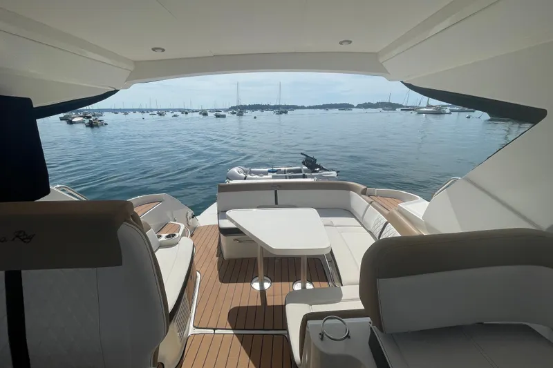 Slide: The Image of 2018 Sea Ray Sundancer 350 Coupe interior with ocean view and seating area. - 7