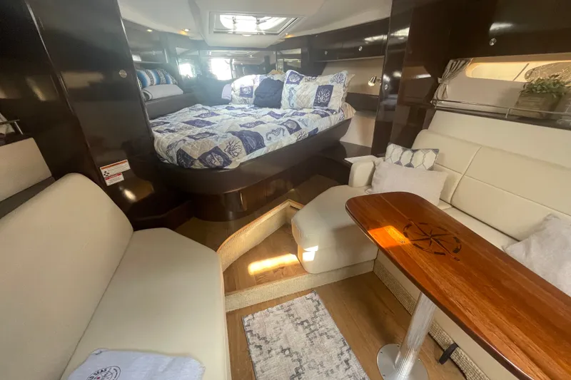 Slide: The Image of Interior of 2018 Sea Ray Sundancer 350 Coupe with cozy seating and elegant wood table. - 18