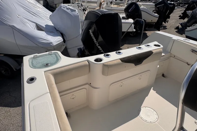 Slide: The Image of 2022 Sailfish 242 CC boat interior with rod holders and storage compartments. - 9