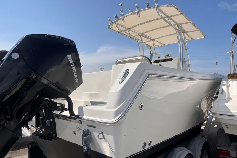 Slide: The Image of 2022 Sailfish 242 CC boat with Mercury engine, featuring sleek design and T-top canopy. - 6