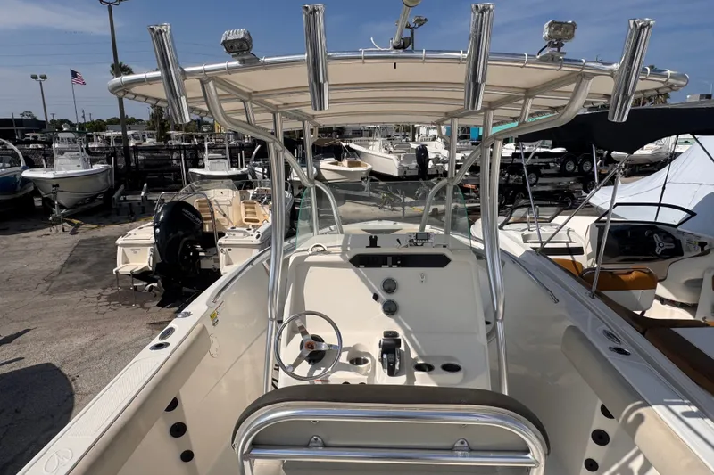 Slide: The Image of 2022 Sailfish 242 CC boat interior with steering console and rod holders. - 7