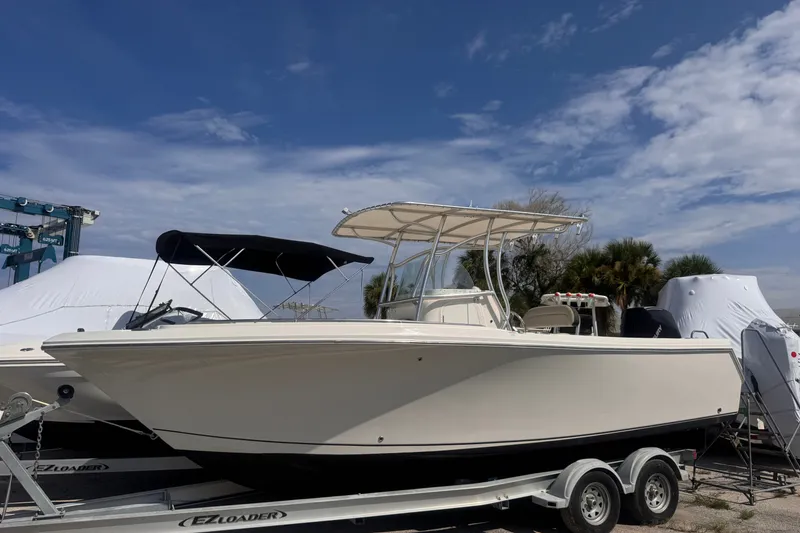 The Image of 2022 Sailfish 242 CC boat on trailer under blue sky. - 1