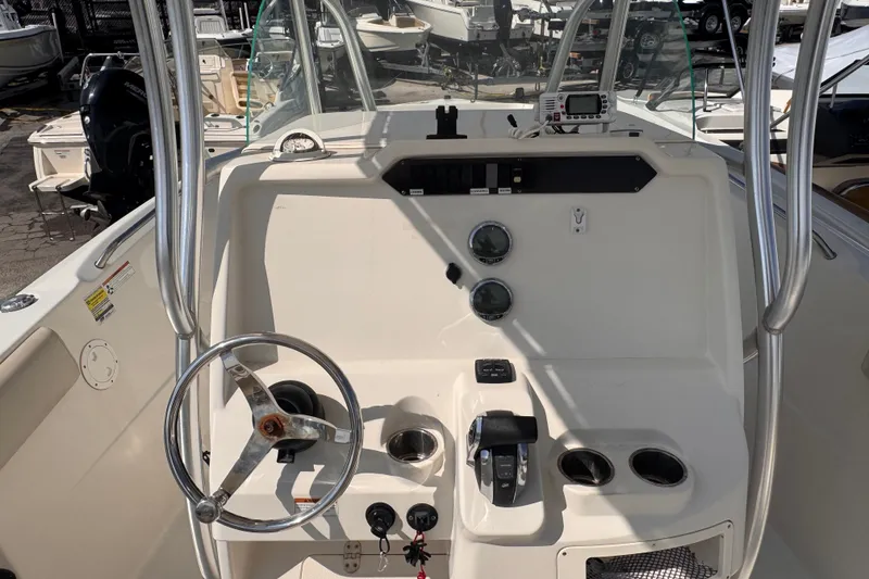 Slide: The Image of 2022 Sailfish 242 CC boat console with steering wheel and controls. - 8
