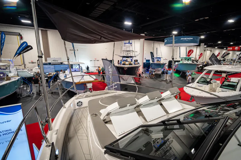 Slide: The Image of Boat show featuring Hanover 347 model, 2026, with various yachts and attendees in a large indoor venue. - 8