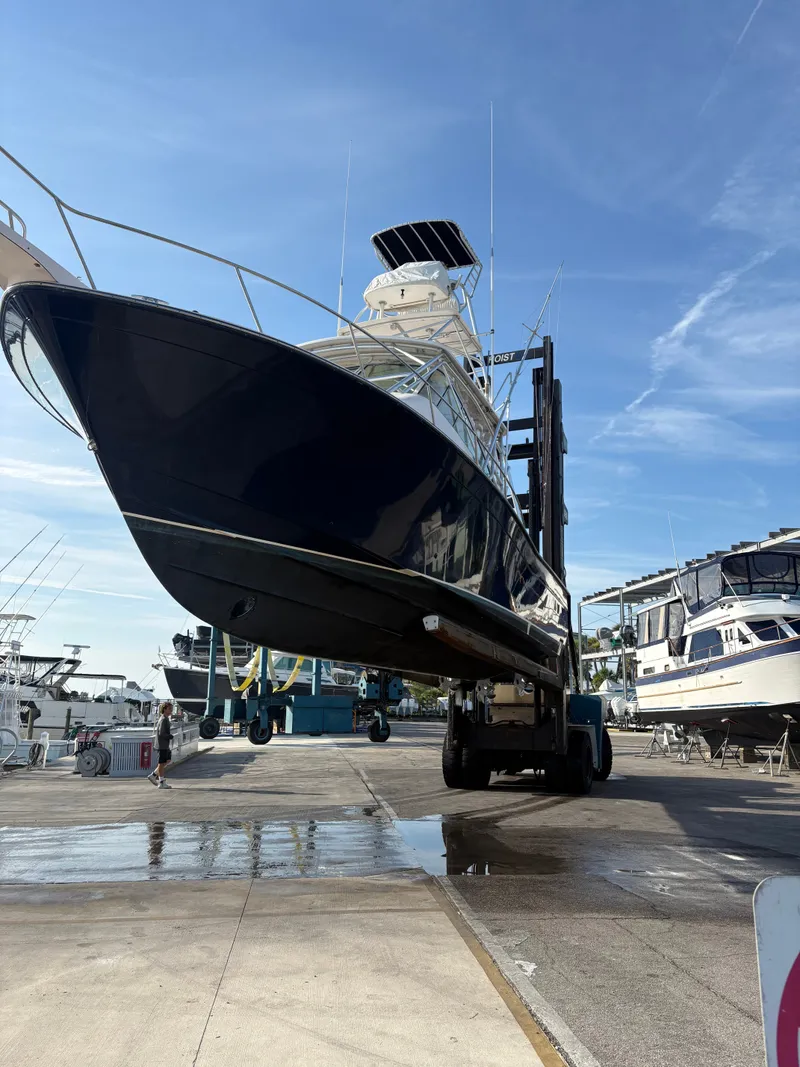 Slide: The Image of A 2005 Grady-White Express 360 being lifted out of the water on a boat lift. - 32