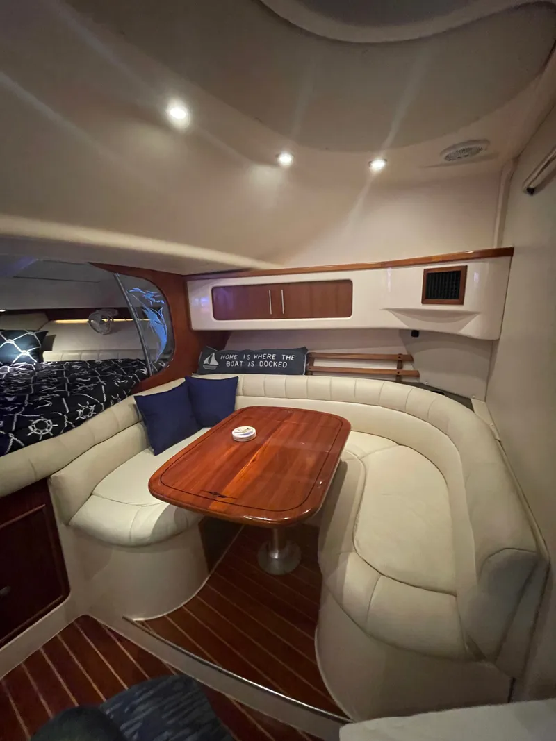 Slide: The Image of Interior of the 2005 Grady-White Express 360 with elegant seating area and wooden table. - 6