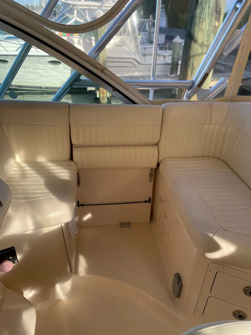 Slide: The Image of The 2005 Grady-White Express 360 features a spacious, cushioned seating area with beige leather. - 16