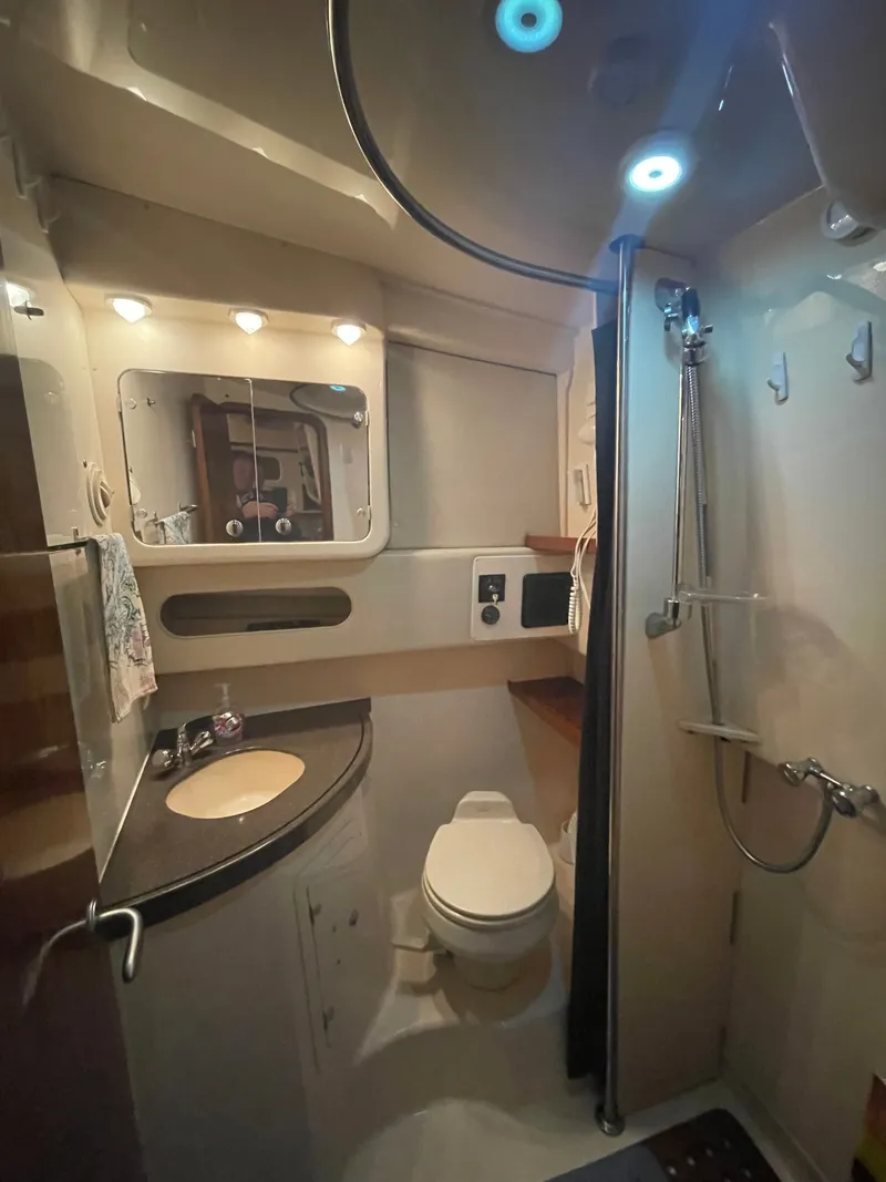 Slide: The Image of The image shows a boat bathroom with a shower, toilet, and sink. - 7