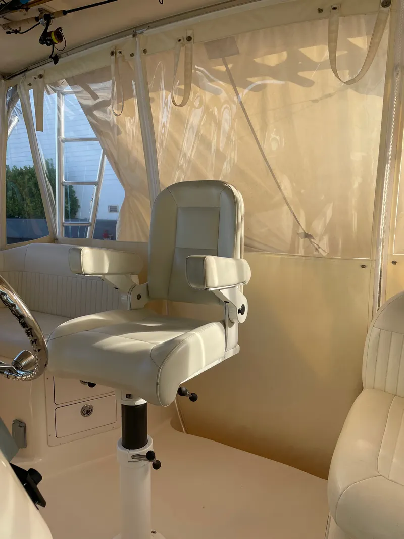 Slide: The Image of A sleek, white captain's chair in a well-lit boat interior. - 18