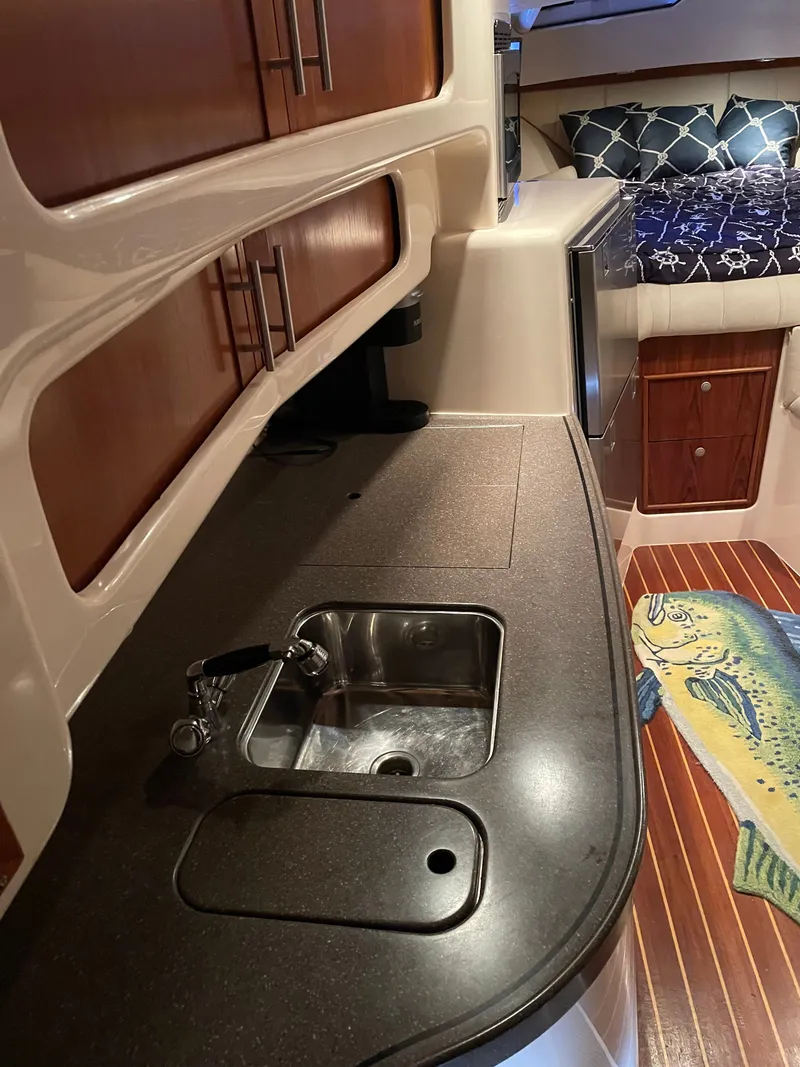 Slide: The Image of The cabin of a 2005 Grady-White Express 360 with a sink and sleeping area. - 11