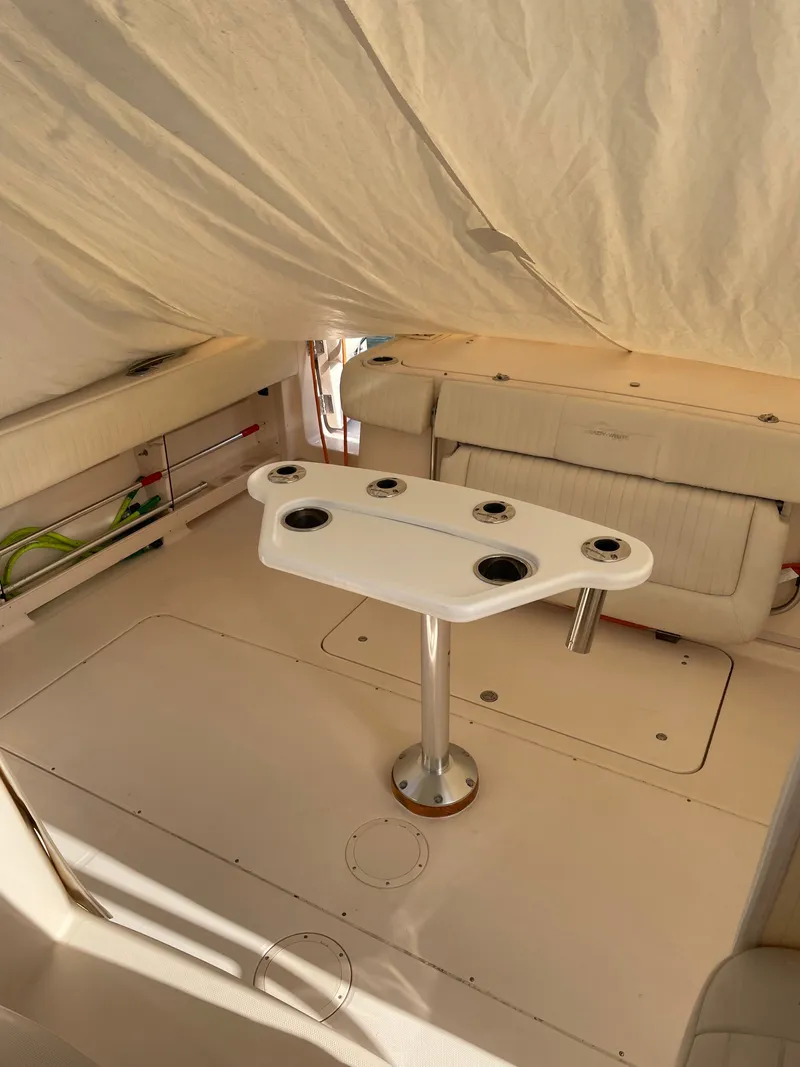 Slide: The Image of Interior of a 2005 Grady-White Express 360 with a table and seating area. - 4