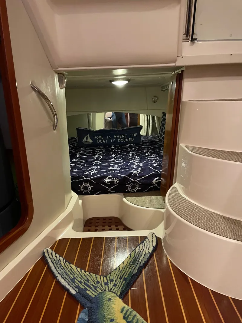 Slide: The Image of Interior of a 2005 Grady-White Express 360 with a cozy bed and nautical decor. - 13