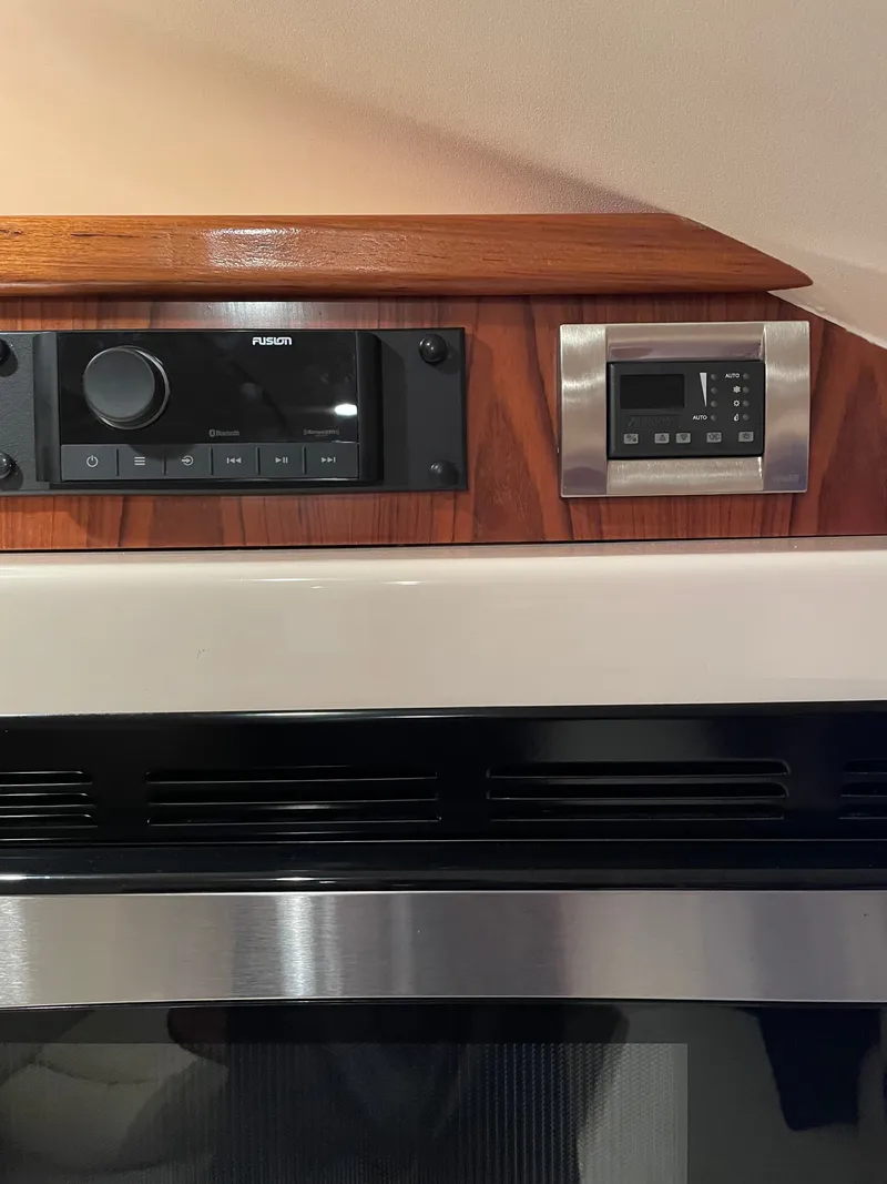 Slide: The Image of Close-up of a boat cabin interior featuring a Fusion audio system and a control panel. - 12