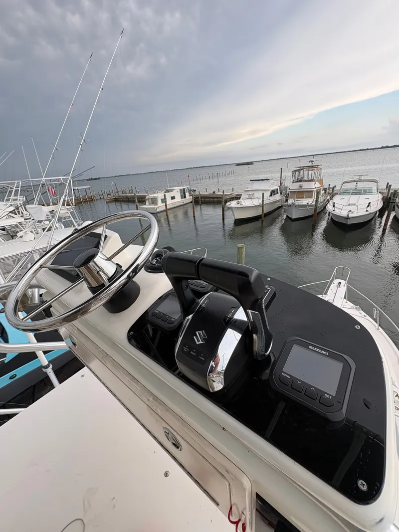 Slide: The Image of The image shows the helm of a 2005 Grady-White Express 360 boat docked in a marina. - 23