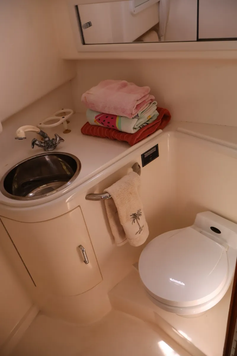 Slide: The Image of The image shows the bathroom of a 2001 Cabo 35 Express with a sink and toilet. - 20