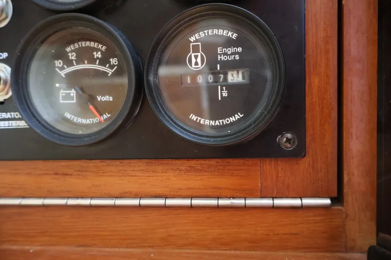 Slide: The Image of Close-up of boat instruments, including a voltmeter and an engine hour meter. - 23