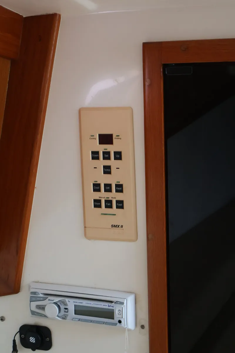 Slide: The Image of A control panel with multiple buttons and a display is mounted on the wall. - 17