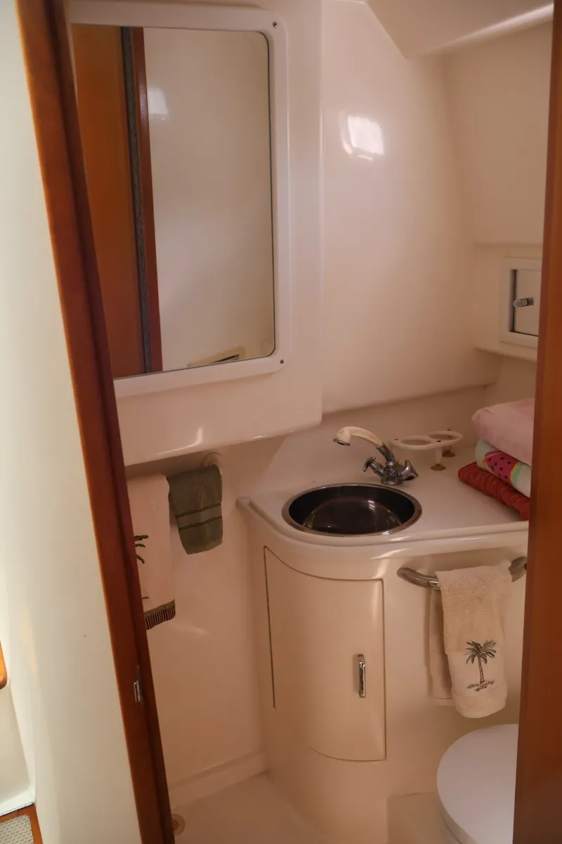 Slide: The Image of The image shows a boat bathroom with a sink and towels. - 19