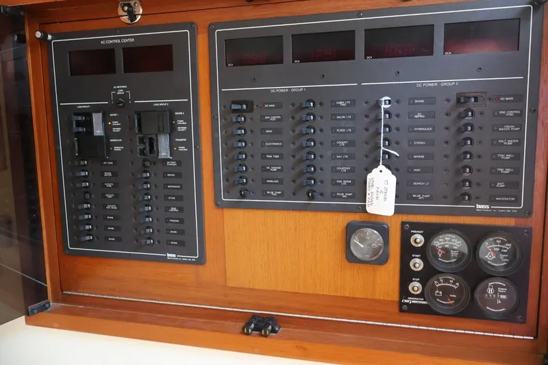 Slide: The Image of Electrical control panel with various switches and gauges in a wooden frame. - 22