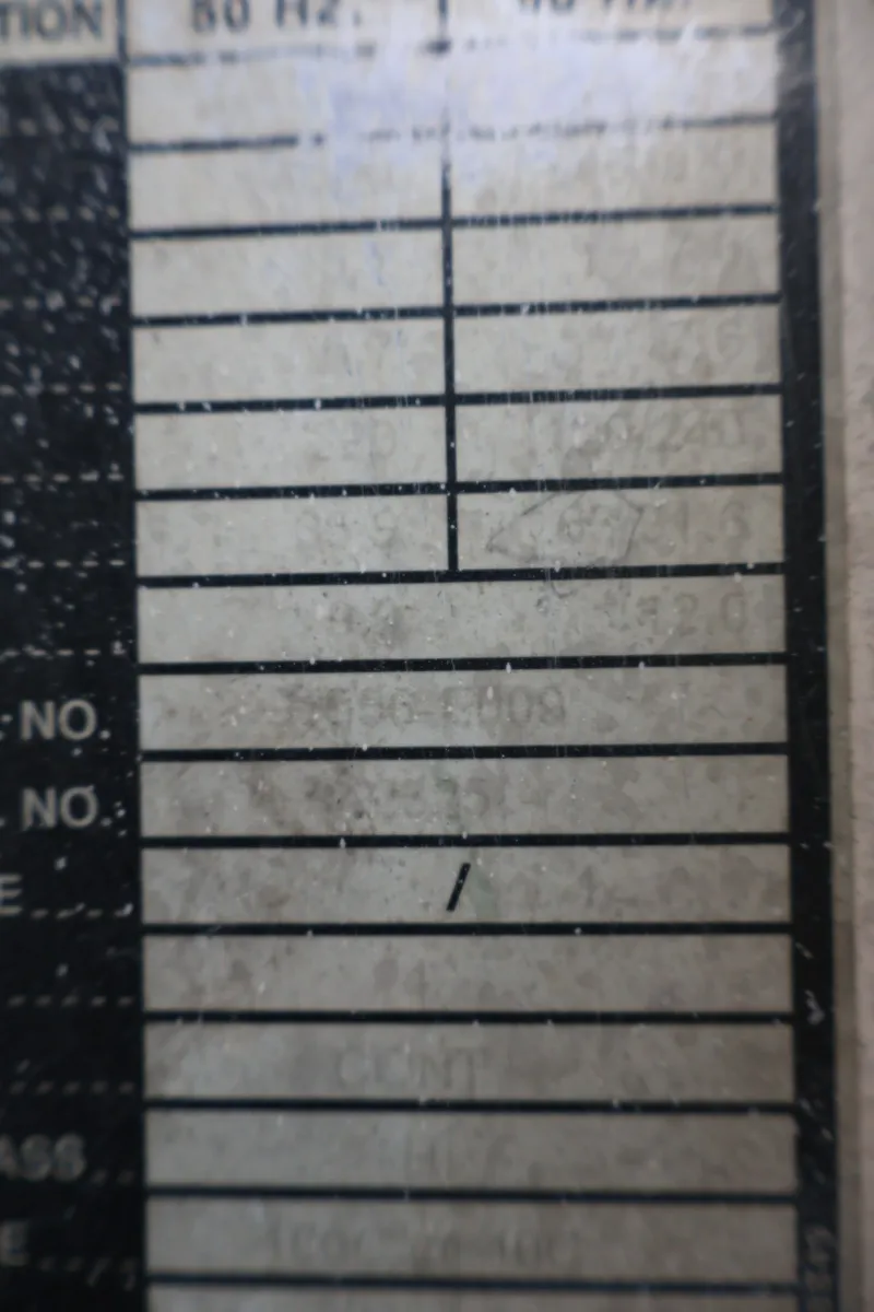 Slide: The Image of Close-up of a weathered label with faded text and lines. - 31