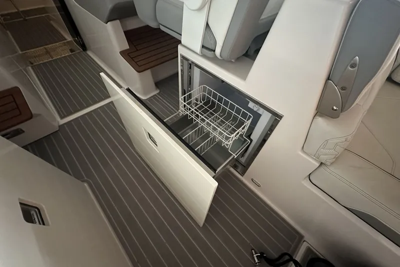 Slide: The Image of 2023 Regal LS36 boat interior with open drawer and seating area. - 12