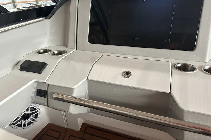 Slide: The Image of Interior of 2023 Regal LS36 boat with control panel and cup holders. - 6
