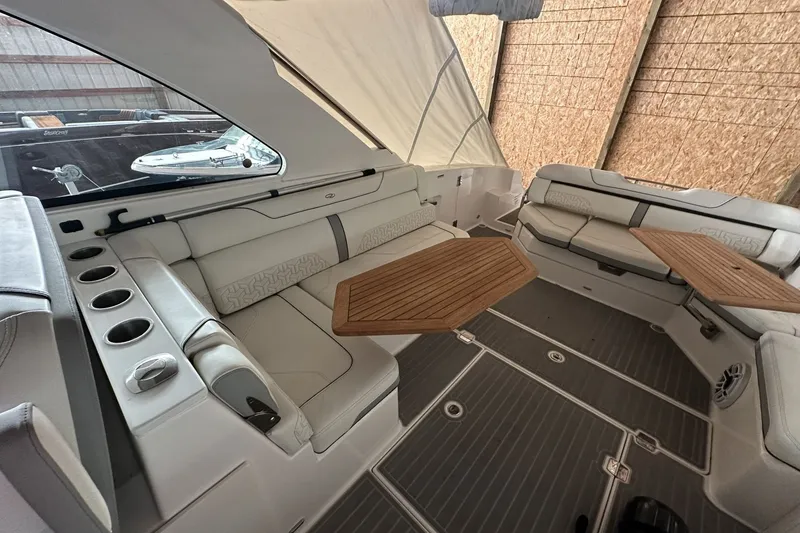 Slide: The Image of Luxurious interior of 2023 Regal LS36 boat with elegant seating and wooden tables. - 8