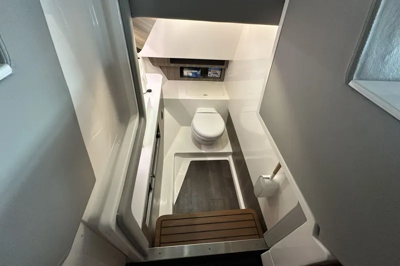 Slide: The Image of 2023 Regal LS36 boat interior bathroom with modern design and wooden accents. - 14