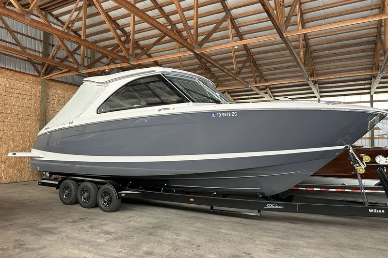 The Image of 2023 Regal LS36 boat on trailer in a wooden storage facility. - 0