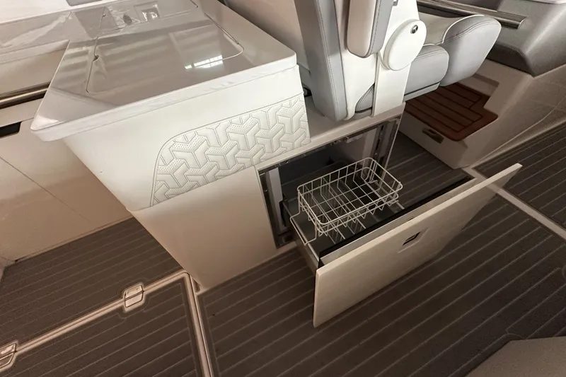 Slide: The Image of 2023 Regal LS36 boat interior with open storage compartment and seating area. - 13
