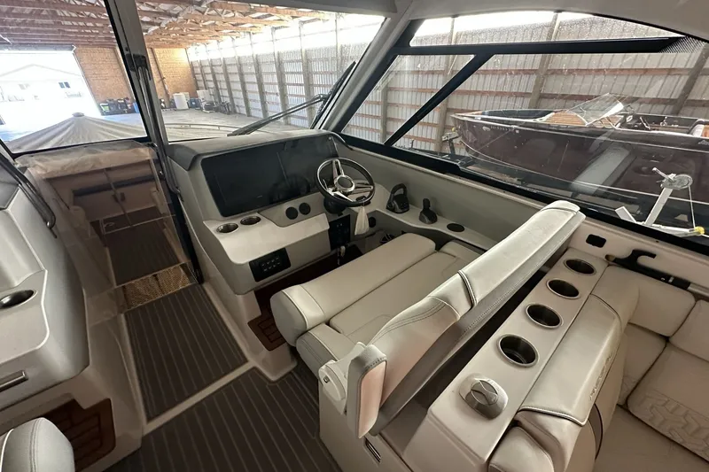 Slide: The Image of 2023 Regal LS36 boat interior with modern helm, steering wheel, and comfortable seating. - 3