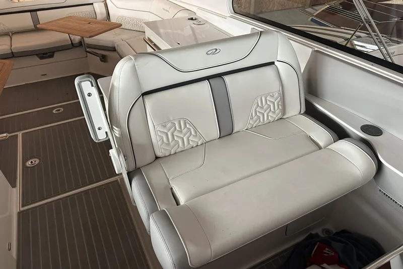Slide: The Image of Luxurious seating on 2023 Regal LS36 boat, featuring elegant white upholstery and modern design. - 7